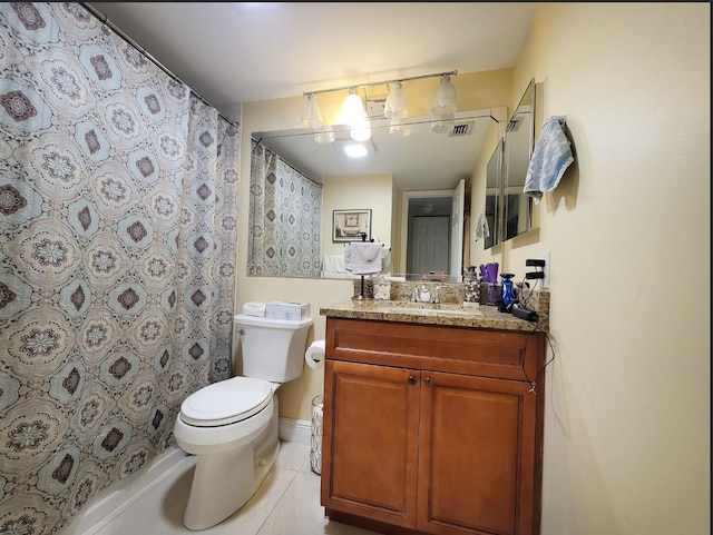 bathroom featuring curtained shower, tile patterned flooring, vanity, and toilet