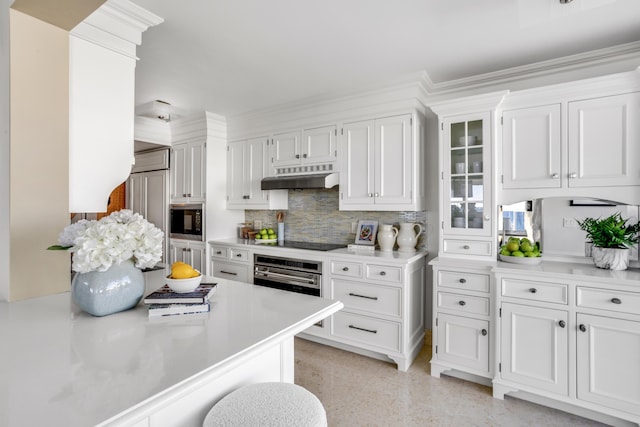 kitchen with backsplash, white cabinetry, oven, and black electric cooktop