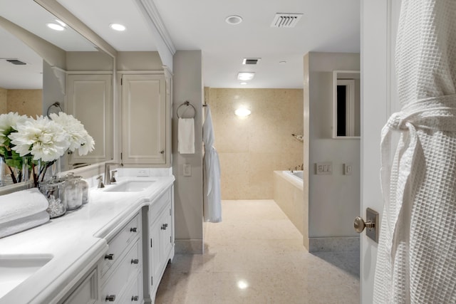 bathroom featuring vanity and a relaxing tiled tub