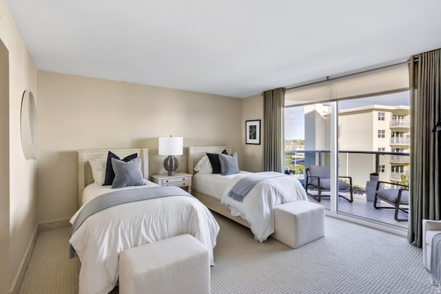 bedroom with access to outside, floor to ceiling windows, and light carpet