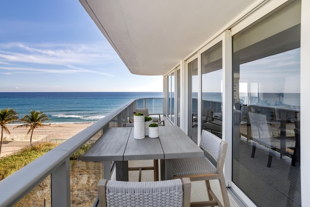 balcony with a beach view and a water view