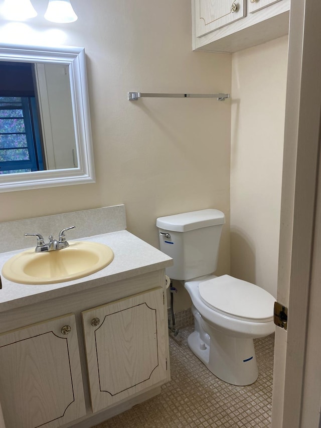 bathroom with tile patterned floors, vanity, and toilet