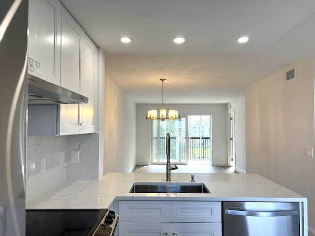 kitchen with a chandelier, white cabinetry, sink, and stainless steel appliances