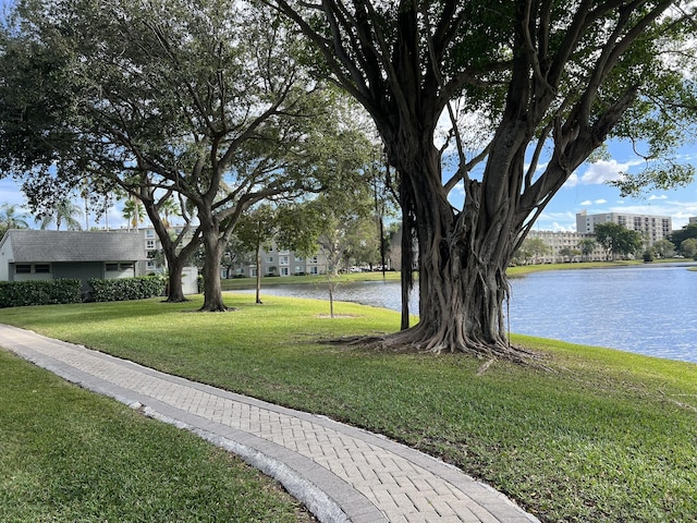 surrounding community featuring a lawn and a water view