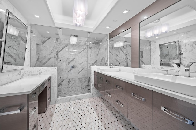 bathroom featuring a raised ceiling, vanity, an enclosed shower, and tile walls