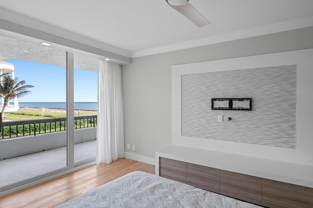 bedroom with ceiling fan, crown molding, access to outside, a water view, and light wood-type flooring