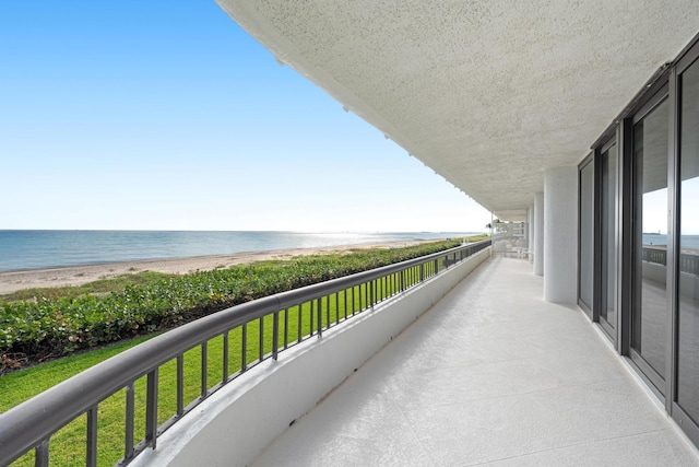 balcony with a beach view and a water view