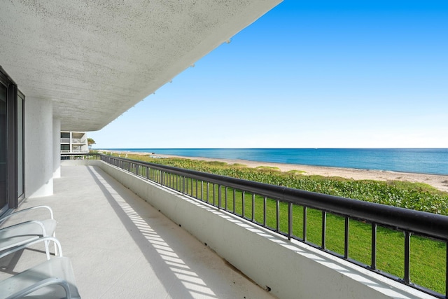 balcony with a beach view and a water view