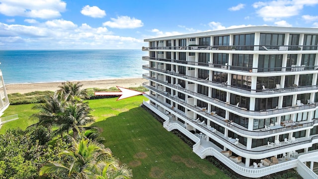 bird's eye view featuring a water view and a beach view