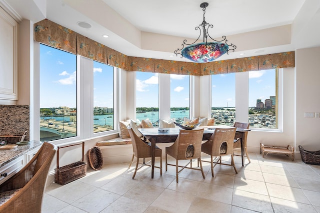 tiled dining space with a water view