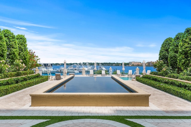 view of swimming pool with a water view