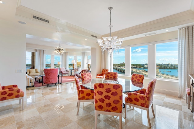 dining space featuring crown molding, a water view, and an inviting chandelier