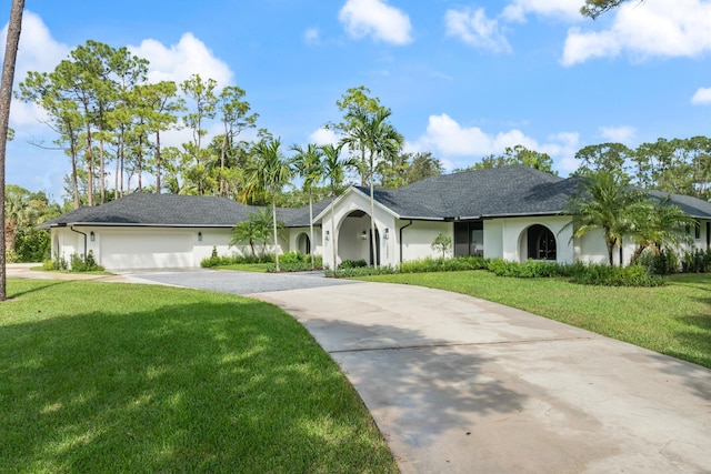 ranch-style home with a garage and a front lawn