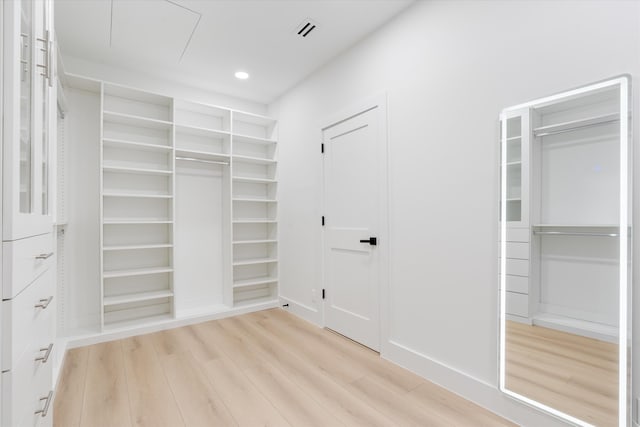 walk in closet featuring light hardwood / wood-style flooring