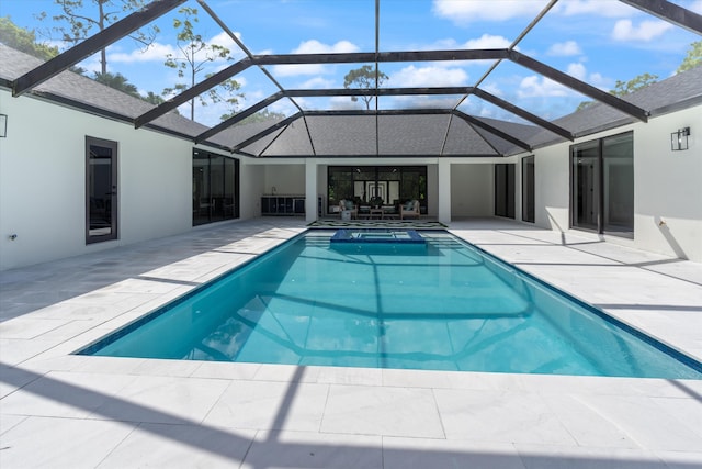 view of swimming pool featuring a lanai and a patio