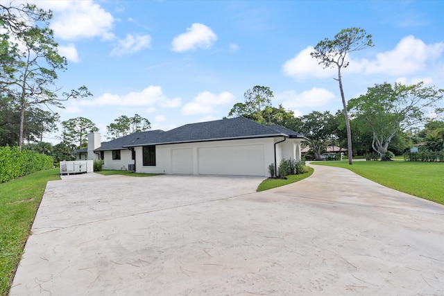 view of front of house with a garage and a front yard