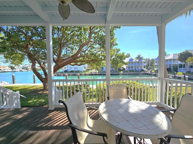 wooden terrace featuring a water view