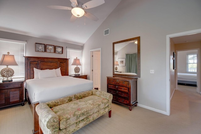 carpeted bedroom with high vaulted ceiling and ceiling fan