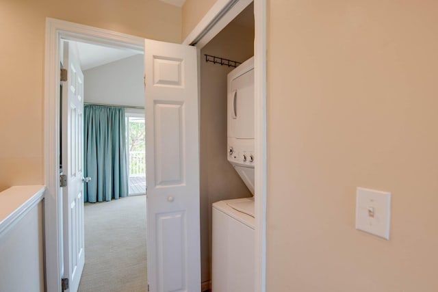 washroom featuring light carpet and stacked washer and clothes dryer