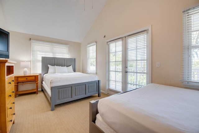 bedroom featuring vaulted ceiling, light carpet, and access to exterior