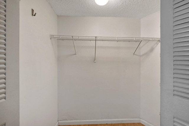 spacious closet featuring hardwood / wood-style floors