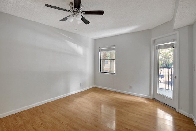 9999 Summerbreeze Dr Unit 1005, Sunrise, FL 33322 - unfurnished room featuring plenty of natural light, light wood-style floors, a textured ceiling, ceiling fan, and baseboards