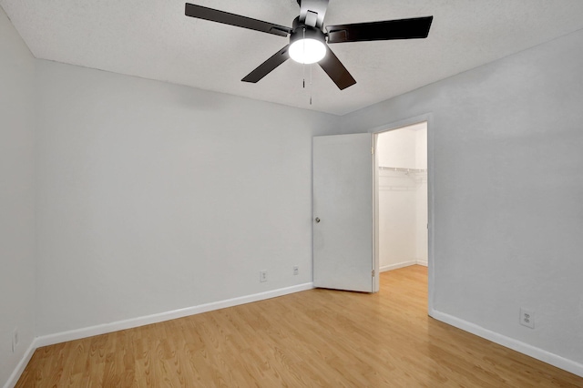 empty room with light wood-type flooring and ceiling fan