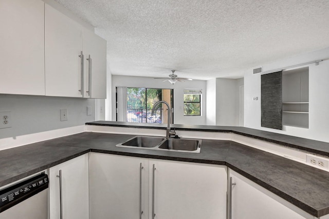 9999 Summerbreeze Dr Unit 1005, Sunrise, FL 33322 - kitchen with a sink, dishwashing machine, a textured ceiling, dark countertops, and white cabinets