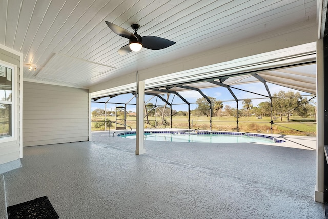 view of pool featuring a patio, ceiling fan, and a lanai