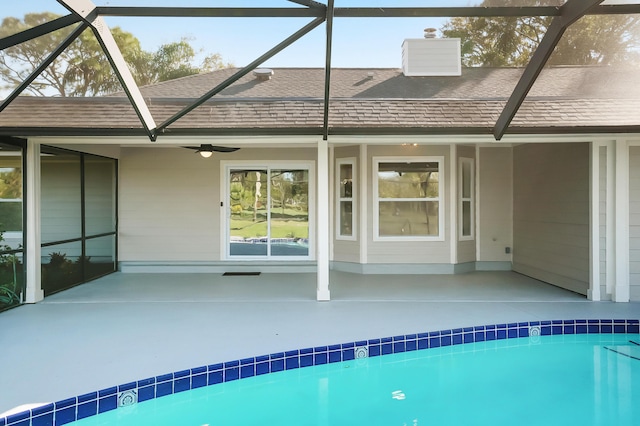 view of pool with ceiling fan, a patio, and glass enclosure