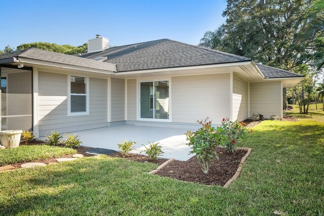 back of house with a patio area, an outdoor living space, and a yard