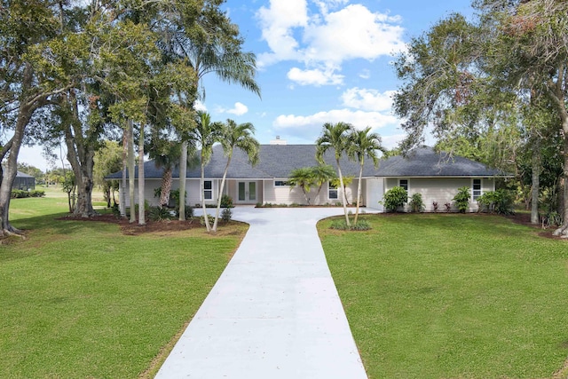 single story home featuring a front lawn