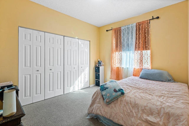 carpeted bedroom featuring a textured ceiling and a closet