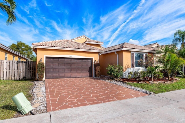 mediterranean / spanish-style house featuring a front yard and a garage