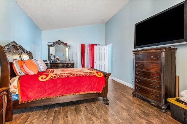 bedroom with lofted ceiling and a textured ceiling