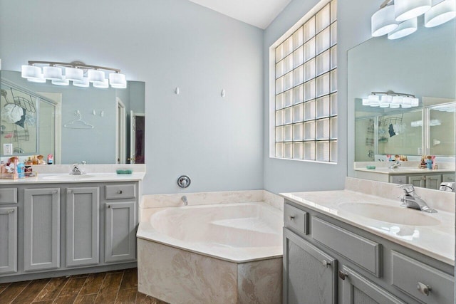 bathroom with vanity and shower with separate bathtub