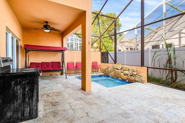 view of patio with a lanai, pool water feature, ceiling fan, a mountain view, and a fenced in pool