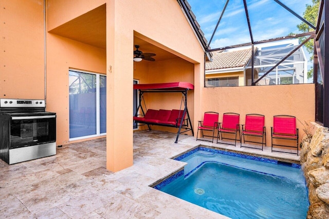 view of swimming pool with a patio area, ceiling fan, and a lanai