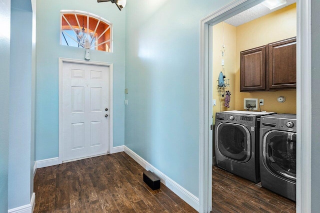 laundry area featuring washer and dryer, dark hardwood / wood-style floors, and cabinets