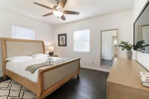 bedroom with dark hardwood / wood-style floors and ceiling fan