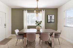 tiled dining space with a healthy amount of sunlight