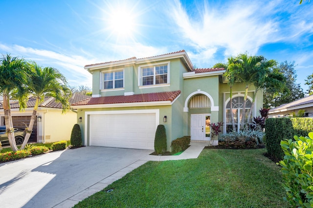 mediterranean / spanish home with a garage and a front yard