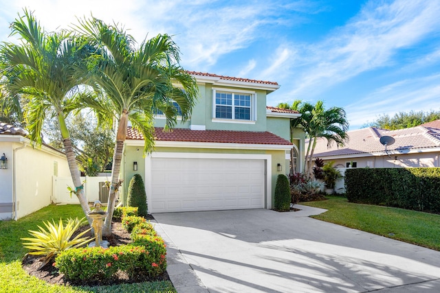 mediterranean / spanish-style house with a garage and a front lawn