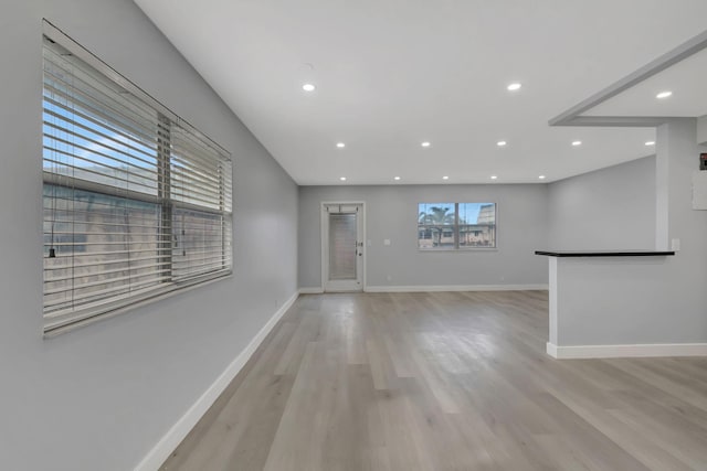 unfurnished living room with light wood-type flooring