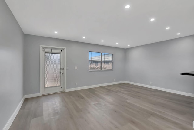 empty room with light hardwood / wood-style flooring