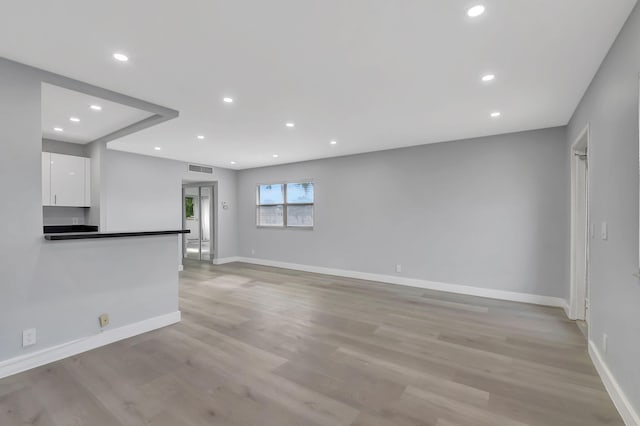 unfurnished living room with light hardwood / wood-style flooring