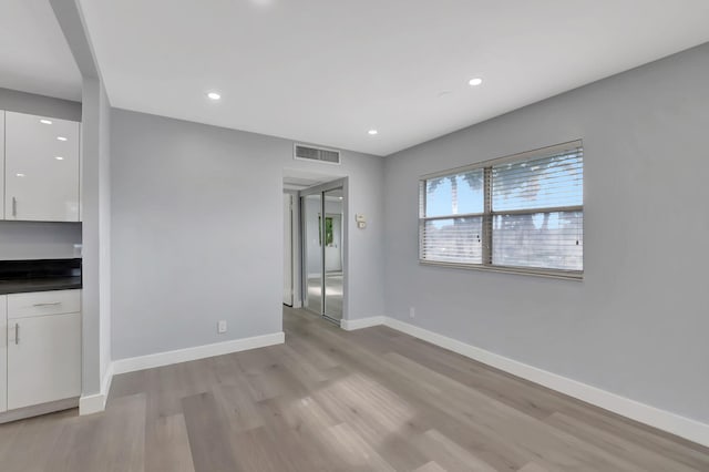 unfurnished living room featuring light hardwood / wood-style flooring