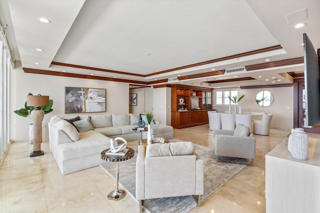 living room with a tray ceiling and crown molding