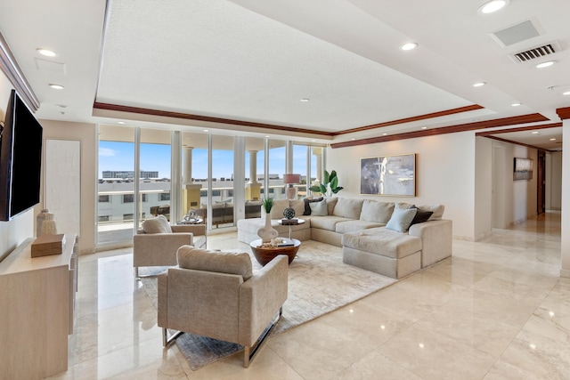 living room with expansive windows, ornamental molding, and a tray ceiling