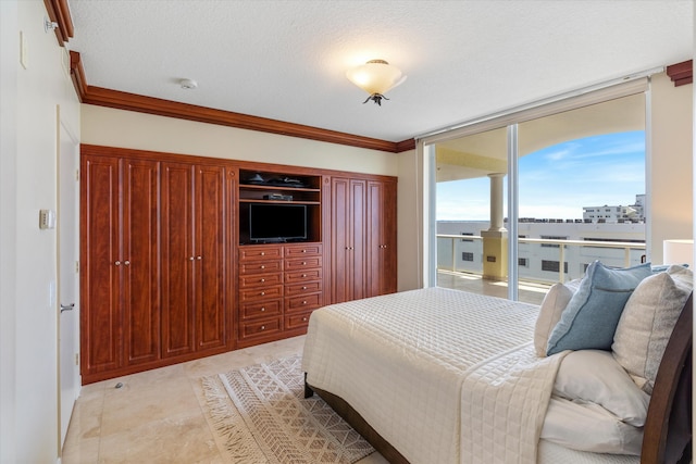 bedroom featuring a textured ceiling, floor to ceiling windows, and ornamental molding